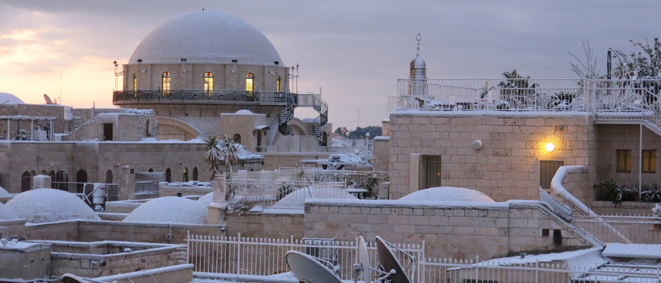 Looking towards Synagogue in Jewish Quarter over snow covered roof tops of Jerusalem Old City