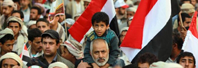 A Yemeni supporter of the Houthi movement carries a boy on his shoulders during a rally in Sana'a, Yemen. Copyright US News.